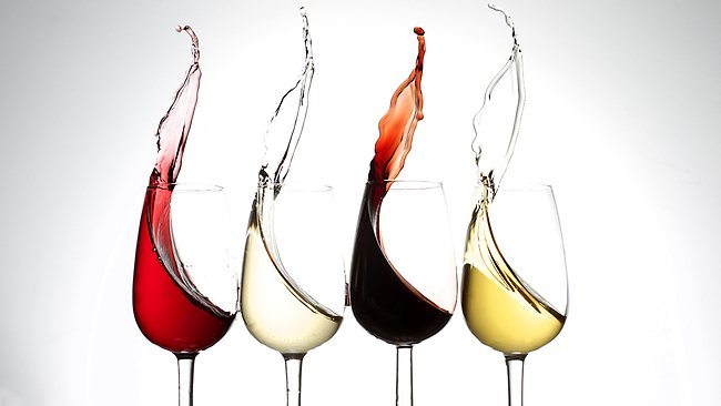 Four types of wine pouring into four wine glasses