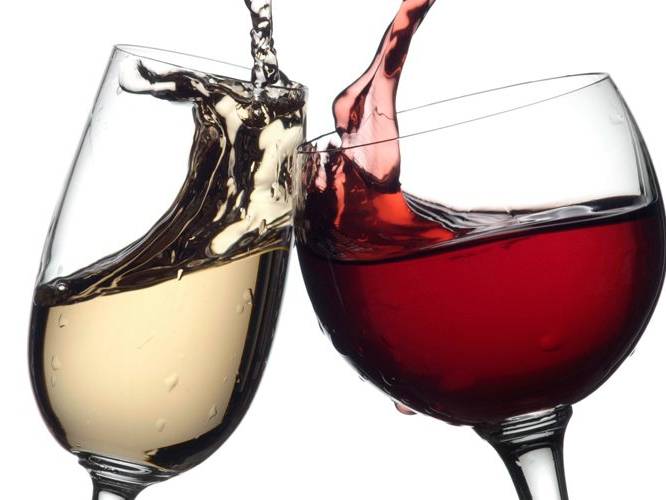 White and red glasses of wine being toasted